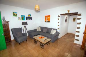 a living room with a couch and a table at BUGANVILLA MOLINO in Tinajo