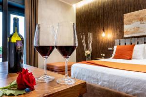 two glasses of wine on a table in a hotel room at casajammone naples b&b in Naples