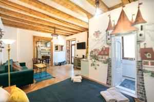 a living room with a room with a house mural on the wall at Saint John's 22 Brasov in Braşov