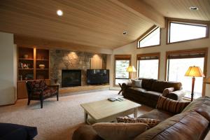 a living room with a couch and a fireplace at 10 Tan Oak Home with BBQ on the Deck in Sunriver
