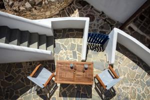 an overhead view of two chairs and a table on a staircase at House Of Kastro in Sikinos