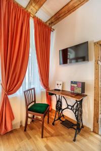 a desk and a chair in a room with a window at Saint John's 22 Brasov in Braşov