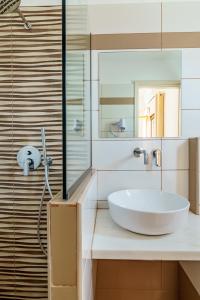 a bathroom with a sink and a mirror at Irini studios in Skiros +52 photos