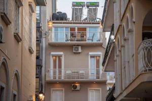 a building with balconies in a narrow street at El Sueño de Zante 2nd City Center Apartments in Zakynthos Town