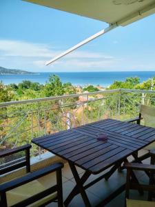 a picnic table on a balcony with a view of the ocean at Dimitra Beach Apartments - Thassos Skala Potamias in Skala Potamias