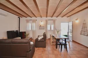 a living room with a couch and a table at ALAMANCHA in Casas de los Pinos