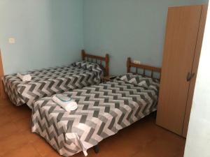 Postel nebo postele na pokoji v ubytování Hostal Casa Alonso + 2 fotografie