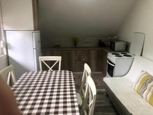 a kitchen with a table and a stove and a refrigerator at Apartman Bojovic in Žabljak +39 photos