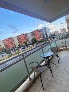 a balcony with two chairs and a table on it at Apartment Vesna City PG in Podgorica