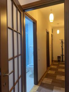 an open door leading to a bathroom with a toilet at Apartment Vesna City PG in Podgorica