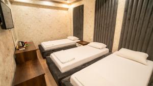 Postel nebo postele na pokoji v ubytování DYMAR HOTEL