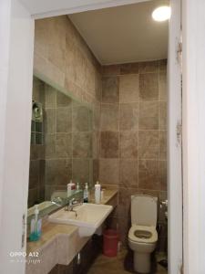 a bathroom with a toilet and a sink at Einbay pool view appartement in Ain Sokhna