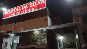 a sign on the side of a building at night at Hostal Da`Silva in Quito