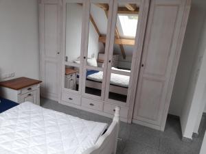 a bedroom with a bed and a large closet at Haus Lehenthaler in Stadtsteinach