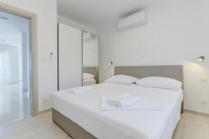 Posteľ alebo postele v izbe v ubytovaní APARTMANI OLIMP