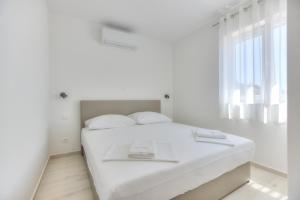 Posteľ alebo postele v izbe v ubytovaní APARTMANI OLIMP