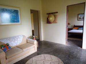 a living room with a couch and a bed at Sítio Pé de Serra in Sobradinho