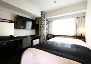 Postel nebo postele na pokoji v ubytování APA Hotel Ueno Ekimae