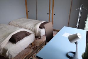 Postel nebo postele na pokoji v ubytování 富貴の里レジデンス