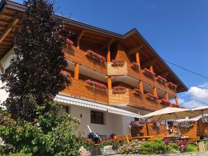 a building with flower boxes on the balconies at Pension Aschlandhof in Obsteig