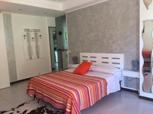 um quarto com uma cama com um cobertor colorido em Big family bed & breakfast em Suello