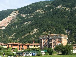 a group of buildings in front of a mountain at Big family bed & breakfast in Suello
