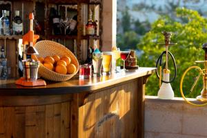 a counter with a bowl of oranges and drinks on it at Lord of Cappadocia Hotel in Göreme