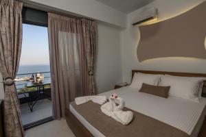 a bedroom with a bed with two swans on it at Elmaky Luxury Apartments in Palaiokastro