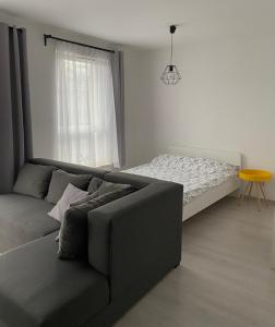 a living room with a couch and a bed at Apartament Bastion Wałowa in Gdańsk