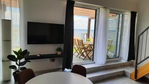 a living room with a large window with a view of the ocean at Apartmán Čtrnáct in Pavlov