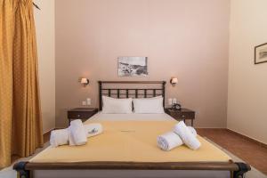 a hotel room with a bed and a dresser at Maistrali Hotel Zante in Tragaki