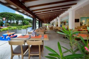 a restaurant with tables and chairs in a building at Alla Pergola in Bibione