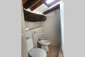 a bathroom with a toilet and a sink at mansarda centro storico in Lucca