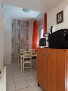 a kitchen with a table and a dining room at Kardos Apartman in Debrecen