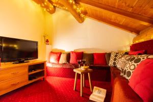 a living room with a couch and a flat screen tv at Chalet Isabella by Chalet Chardons in Tignes