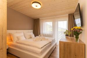 a bedroom with a large bed and a window at Villa Gloria Rooms & Apartments in Donovaly