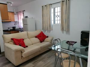 a living room with a couch and a glass table at El Gallinero de Rita in Gaucín +13 photos