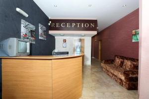 a lobby with a reception desk and a couch at La Piazza Family Hotel in Sunny Beach