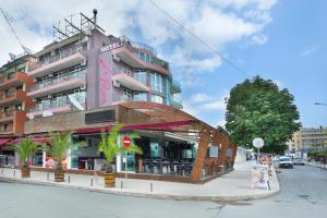 a building on the side of a street at La Piazza Family Hotel in Sunny Beach