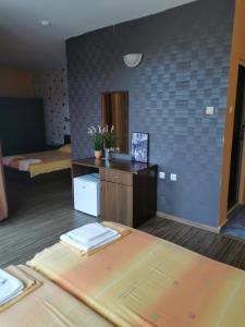 a hotel room with a bed and a mirror at La Piazza Family Hotel in Sunny Beach