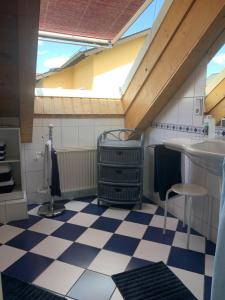 a bathroom with a sink and a checkered floor at Haus Valentina in Waldsolms