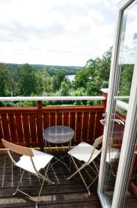 a patio with two chairs and a table on a deck at Nordic Refuge B&B in Fröskog