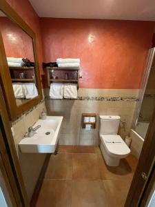 a bathroom with a toilet and a sink at Fonda Mitjà in Torroella de Montgrí