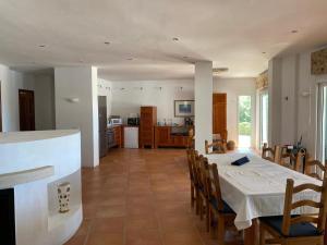 ein Esszimmer und eine Küche mit einem Tisch und Stühlen in der Unterkunft Villa Vivaldi 100m sea & panoramic sea view in Cala Pi