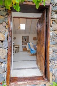 an open door into a room with a stone wall at Casa Leandra con jacuzzi in Adeje