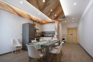 a kitchen and dining room with a table and chairs at Mola’s Square House in Mola di Bari