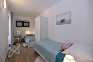 Postel nebo postele na pokoji v ubytování Apartment in Casa Porta Luna, Gajac, Novalja