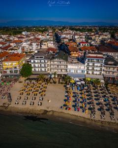 an aerial view of a beach with chairs and umbrellas at Hotel Avra in Paralia Katerinis