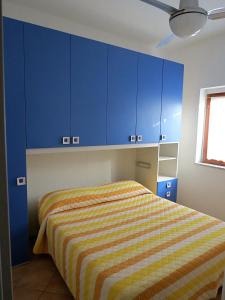 a bedroom with blue cabinets and a bed at Residence Covo degli Dei in Milazzo +75 photos