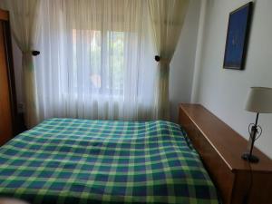 A bed or beds in a room at Apartman Draga
